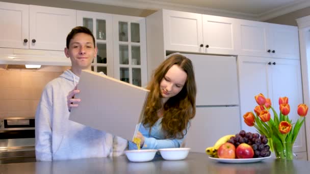 Adolescenti Ragazzi Ragazza Cucina Colazione Versata Una Scatola Cereali Sulla — Video Stock