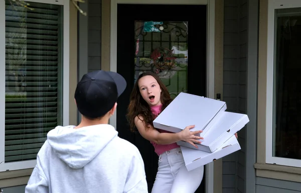 incorrect ugly failed pizza delivery delivery guy threw three untitled boxes to girl near door of house she caught opened her mouth surprised shocked dissatisfied customer bad delivery trouble scandal
