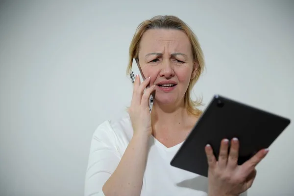 Woman Seriously Tense Annoyed She Standing White Background Talking Phone — Stok fotoğraf