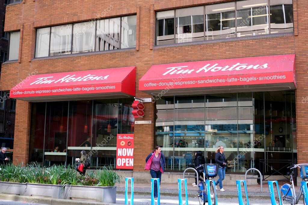 Tim Hortons cafe people passing by Bicycle parking Big city life downtown restaurant snack fast food delicious Vancouver Canada 2023