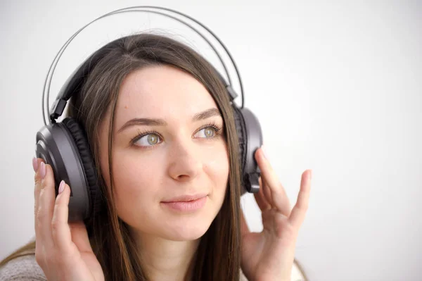 stock image Cute little girl portrait wearing big wireless headphones. Pretty child listening to the music, head shot. High quality photo