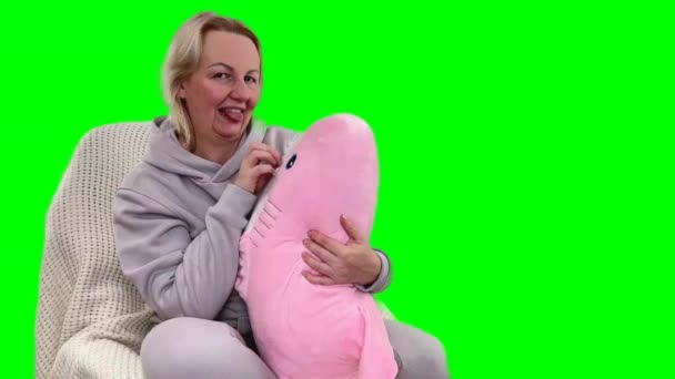 Woman Warm Sportswear Holds Pink Shark Soft Toy She Smiles — Stock Video