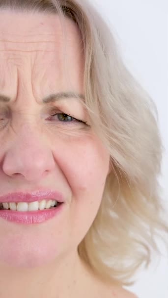 Photo Thoughtful Woman Bites Lower Lip Looks Dreamy Expression Aside — Video Stock