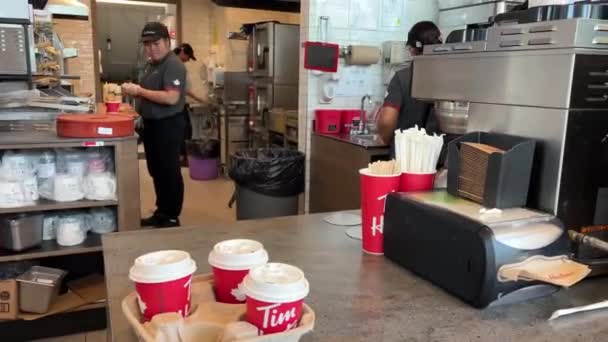 Tim Hortons Salespeople Preparing Food Kitchen Red Glasses Inscription Table — Stock Video