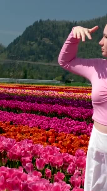 Portrait Curious Young Girl Woman Field Tulips Holding Her Hand — Stock Video