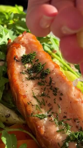 Different Greens Salad Red Fish Salmon Poured Lemon Juice Squeezed — Stock Video
