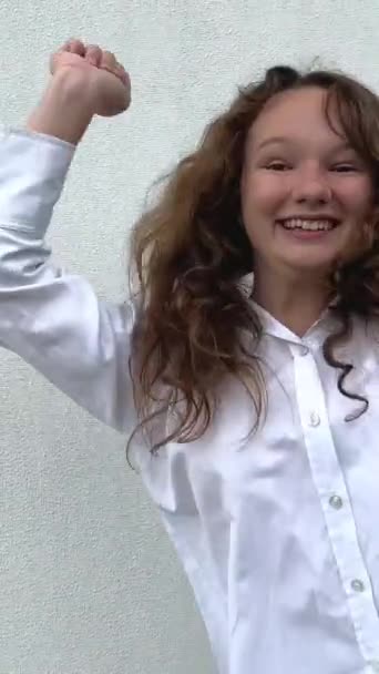 Teenage Girl White Shirt Jumps Dances Waves Her Arms Background — Stock Video