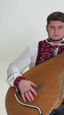 a handsome middle-aged man plays a musical ethnic Ukrainian instrument victory of Ukraine independence and invincibility glory to Ukraine glory to heroes musician 