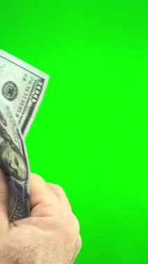 Mans hands closeup, counting United States money, against green screen. High quality 4k footage