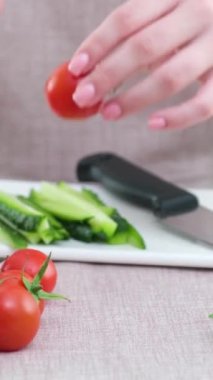 Smiling young woman serving fresh salad on plate. Happy smiling cute woman cooking fresh healthy vegan salad at home with many vegetables in kitchen and trying new recipe High quality photo