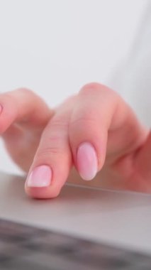 Close-up of female hand touching buttons of white computer keyboard. High quality photo