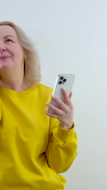 Surprise Embarrassment Shame Woman Orange Yellow Sweater Stands Hands Phone — Stock Video