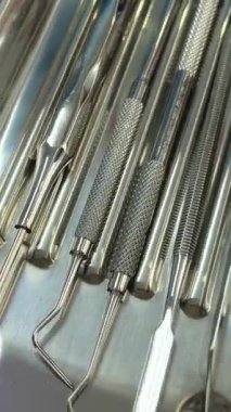 Unrecognizable Dentist Doctor In Blue Sterile Glove Holding Dental Tools In Hand Demonstrating Mouth Mirror, Probe And Stainless Tweezers, Creative Banner For Quality Stomatological Services