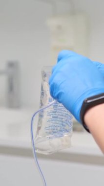 saline gloves dentistry The nurse collects the saline solution of sodium chloride from bottle into the syringe. Antibiotic breeding, vaccination, prevention and treatment of diseases