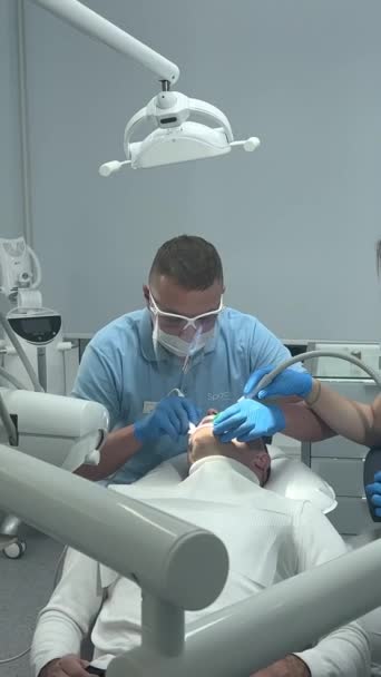 Doctor Blue Gloves Applies Ointment Patients Teeth Shows Cleaning Polishing — Vídeo de Stock