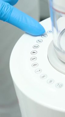 Device for deep cleaning of teeth from tartar Cleaning stones plaque newest apparatus Dentistry new inventions Airflow doctor in blue gloves turns on apparatus Ukraine Vinnitsa Salon Space 26.12.2022