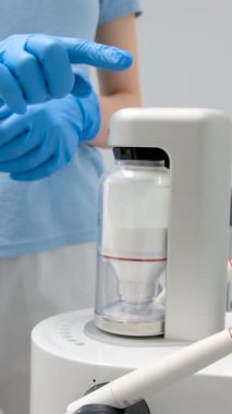 Device for deep cleaning of teeth from tartar Cleaning stones plaque newest apparatus Dentistry new inventions Airflow doctor in blue gloves turns on apparatus Ukraine Vinnitsa Salon Space 26.12.2022