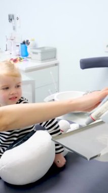 Genç doktor dişçi koltuğunu ilk kez gösteriyor. Mutlu bir mutluluk gülümsemesi. Hoş sohbetler. 