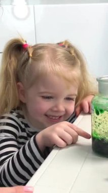 Elementary School Science Chemistry Classroom: Enthusiastic Teacher Shows Funny Chemical Reaction Experiment to Diverse Group of Children. Mixing Chemicals in Beaker so they Shoot Foam