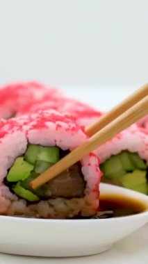 California Maki Sushi with Masago Roll made of Crab Meat, Avocado, Cucumber inside. Masago smelt roe outside. High quality photo