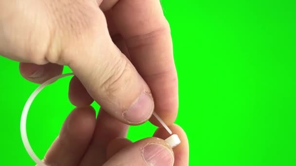 Green Background Chromakey Man Fastens Nylon Tie His Own Hands — Stockvideo