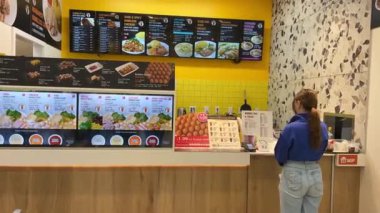 Fast food kafe fast food yapan kızlar mavi bluzlu genç kızı pişiriyorlar menü fotoğraflarını bekliyorlar sıradan yemeklerin sıradan yemeklerin Vancouver Kanada 'daki basit yemeklerin 09.09.2023