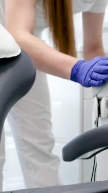 Diş temizleme bürosu nemlendiricisini steril bez teçhizat lavabosuyla temizler diş sandalye dezenfeksiyonu temizliği temizliği, temizlikçi kız hemşire ve ıslak peçeteli hijyen eldivenleri. temizlik