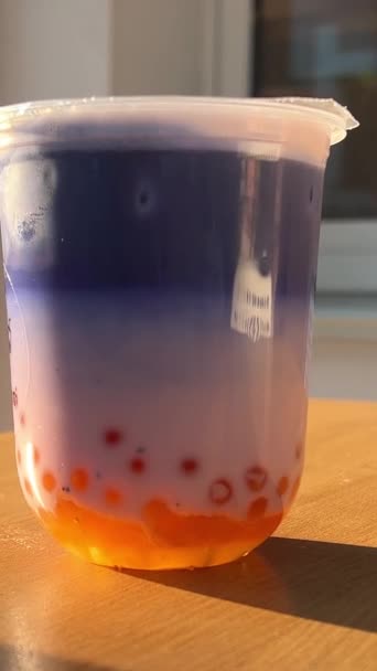 Bubble Tea Orange Balls Lilac Blue Drink Wooden Table Sunny — Stock Video