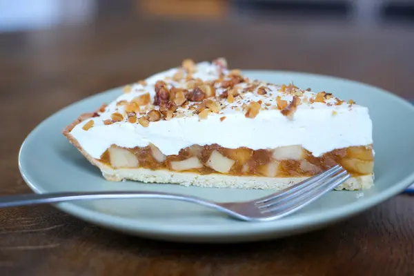 delicious apple charlotte on shortcrust pastry with mascarpone cheese and walnuts on top, break the delicate layer with a fork and the filling close-up macro video footage on a plate in a restaurant