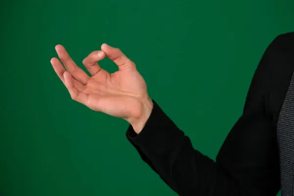 on a green background chromakey close-up dark hair young man meditation hands in the shape of a lotus close-up right and left hands separately. two photos