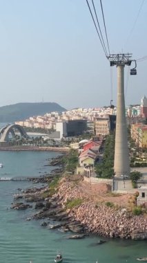 Phu Quoc Adası 'nın güneyinde gün batımında ufuk çizgisi üzerinde açık gökyüzü olan bir teleferik. Denizdeki gemiler