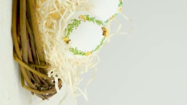 easter holiday banner side view of eggs in nest lavender flowers ribbon embroidery on eggshell white eggs lie on straw on right space for text advertising ads postcard billboard easter holiday