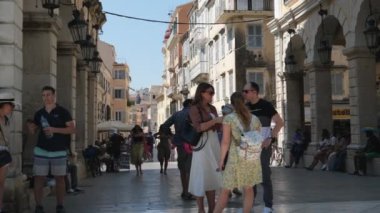 Korfu adasındaki dar sokaklar, yüksek sarı binalar, şehir mıknatısları etrafında dolanıyor. Satış hayatı turistik bir şehirde, gökyüzü yüksekliğindeki binalarda sallanıyor. Yunanistan 09.09.2023