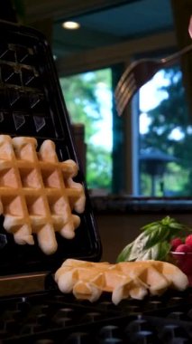 Beyaz bir tabakta, açık ahşap arka planda Belçika waffle 'ları. Doldurulmamış waffle. Yüksek kalite 4k görüntü