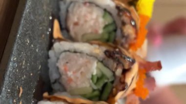 Black DRAGON ROLL Yengeç Eti, Avokado, Kappa Unagi, Avokado, Balık Gevreği ve Çiçekle süslenmiş Balık Restoranı