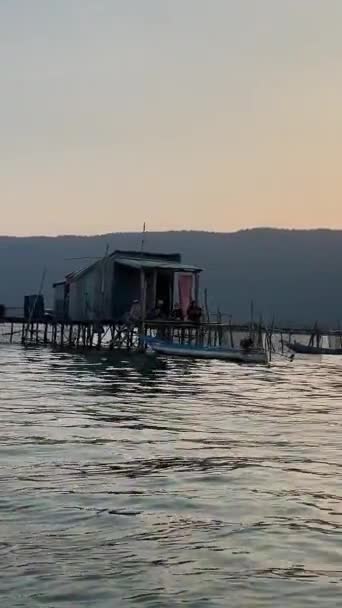 印度洋捕鱼船上的渔民们在越南的养鱼场捕到了鱼 在水面上的餐馆捕鱼网木房子无云的天空和平静的水 — 图库视频影像