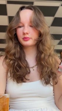 Modern Smartphone 'da Yürüyen Kız Mesajları Yazıyor. Kupa 'yı sol elinde tutuyor. Güzel bayan telefonuyla meşgul. Kayar ve eğlenceli makaleler okur..