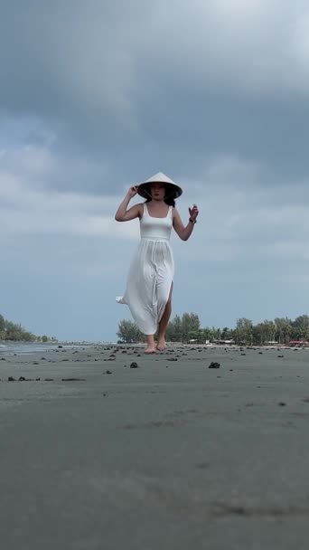 Young Woman Empty Beach White Dress Walks Sand Holding Her — Stock Video