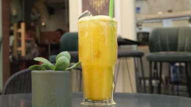 Kız bir tüp ile cam şişe portakal suyu kalıntısı tamamlandıktan