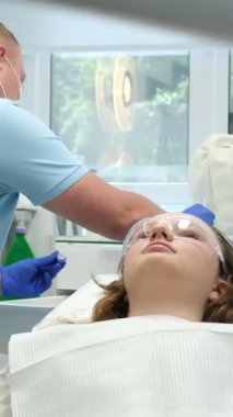 Erkek dişçi klinikte dişlerini tedavi ediyor. Yüksek kalite 4k görüntü