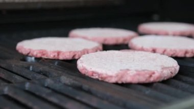 PlantBased Frozen Burgers Frying in Pan with Camera Pulling Focus
