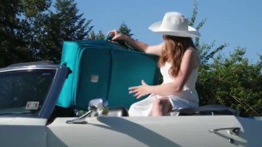 Girl happy travel suitcases car summer landscape Young woman taking green suitcase from car trunk. Travel and vacations concept.