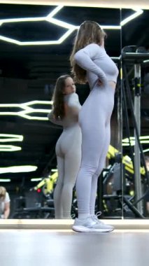 Woman doing pull-up. Strong girl in sportswear doing pull up exercise. H3althy