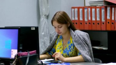 Ofisteki hiçbir ısıtıcı kız bilgisayarda çalışan bir paltoyla üstünü örtmedi. Ofiste çalışmak çok soğuk.