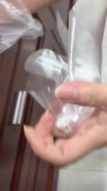 Tek kullanımlık şeffaf eldiven takan kadın elleri koruyucu eldiven kullanıyor. Tek kullanımlık şeffaf eldivenler giy.