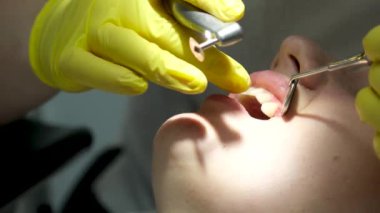 Dentists hands giving anesthetic injection to female patient during dental procedure in clinic. Doctor making anesthetic injection to woman in dentistry office. Dental treatment concept.