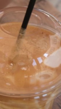 Köpüklü çay, aynı zamanda inci sütü ya da köpüklü süt olarak da bilinir. Döndürme hareketi. Tek kullanımlık plastik bardak. Satış Bayrağı, sokak kafesi için şarjör.