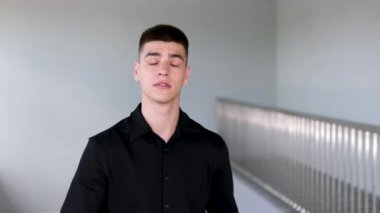 Süveterli, şoke olmuş, ağzı açık, inançsız genç bir İspanyol. Korkmuş, şaşırmış bir yüz, beyaz arka planda tek başına duruyor. Şaşkınlık sürprizi