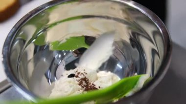 Şekerlemeler, pişirme ve pişirme konsepti. Evdeki mutfakta pasta yapan kadın. Bento keki yapma süreci. Elinde kremalı ahudududulu kek tutan kadın.