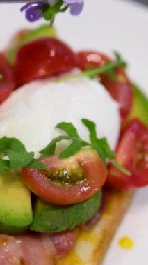 Ekmek ve domatesli Benedict usulü yumurta ve Becon Morning sandviçi. Hollandaise soslu yumurta ve kızarmış somon.